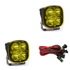 Baja Designs Squadron Sport Spot LED light pods in amber with mounting brackets and wiring harness for offroad vehicles.