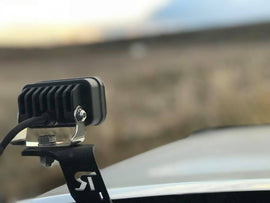 Baja Designs S2 Sport Pair Wide Cornering LED lights mounted on a vehicle, designed for enhanced visibility and off-road performance.