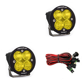 Baja Designs Squadron R Sport amber LED light pods with mounting brackets and wiring harness for offroad vehicles.