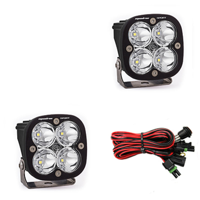 Baja Designs Squadron Sport Spot LED light pods with clear lenses and wiring harness for offroad lighting solutions.