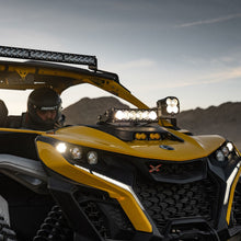 Load image into Gallery viewer, Baja Designs Can-Am Maverick R Clear 10in OnX6+ Shock Tower Kit installed on a yellow UTV, showcasing powerful off-road lighting.