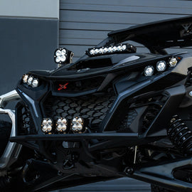 Baja Designs Can-Am Maverick R Clear 10in S8 Shock Tower Kit showcasing front lighting and rugged design for offroad performance.