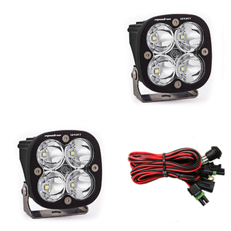 Baja Designs Squadron Sport LED light pods in clear with mounting brackets and wiring harness for offroad lighting.