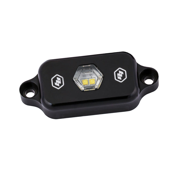 Baja Designs LED rock light in clear, featuring a compact design and durable housing for off-road illumination.