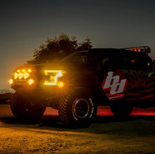 Load image into Gallery viewer, Baja Designs LP6 Pro amber spot lights illuminate a truck at night, showcasing offroad capabilities and style.