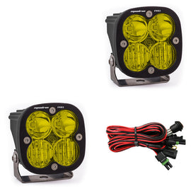 Baja Designs Squadron Pro LED cubes with yellow lenses and wiring harness for off-road lighting enhancement.