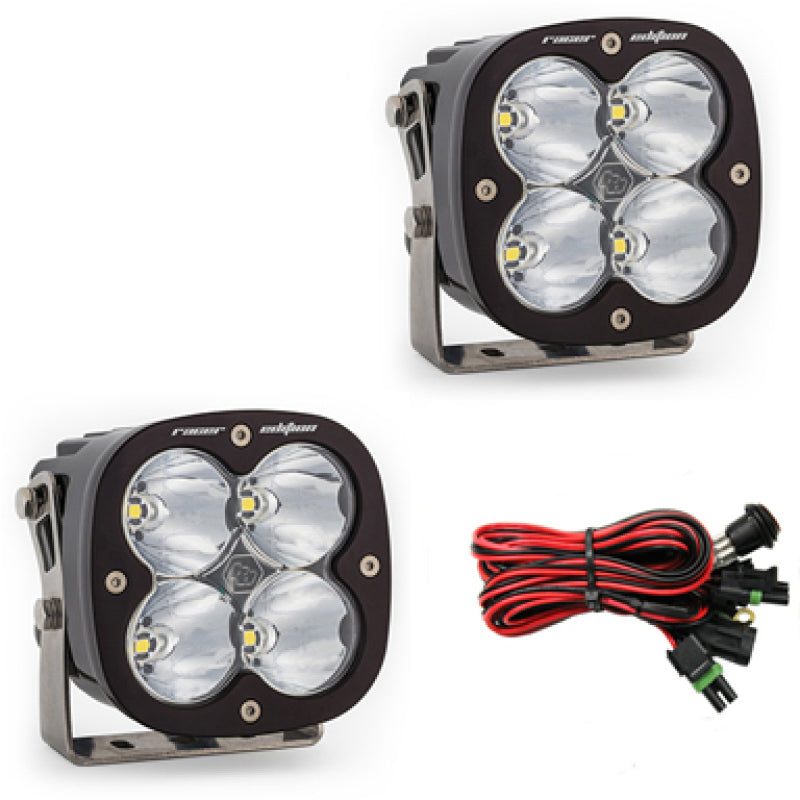 Baja Designs XL Racer Edition LED light pods with four clear lenses, mounting brackets, and wiring harness for high-speed visibility.