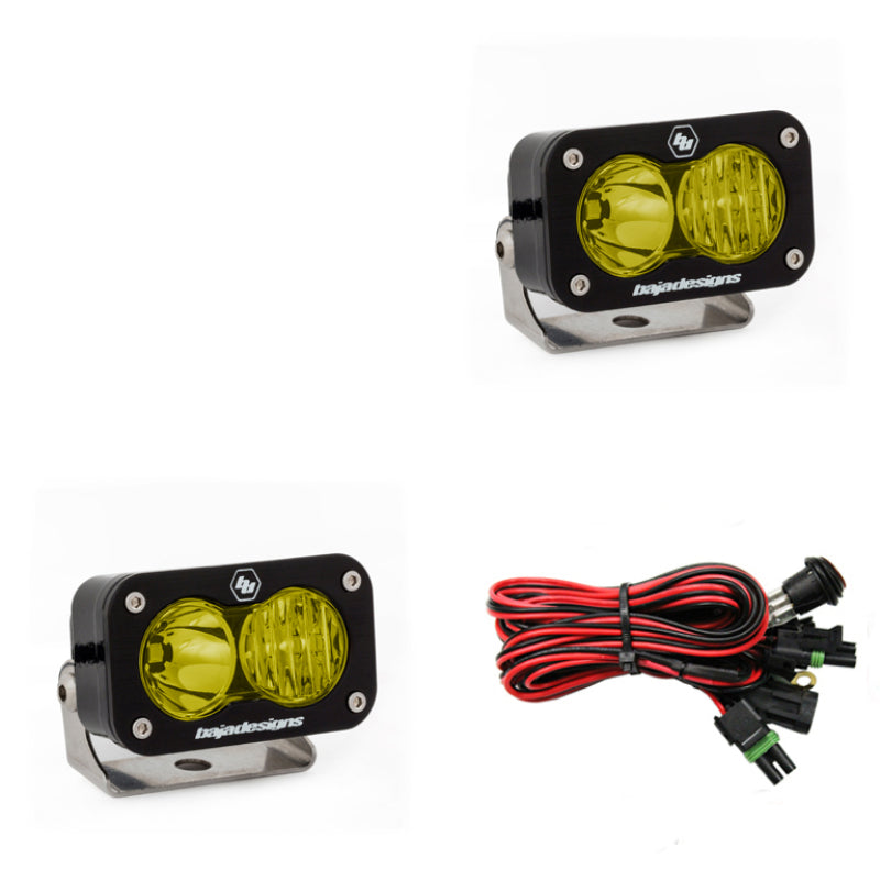 Baja Designs S2 Pro Wide Cornering Pair LED lights in amber with wiring harness for offroad vehicles.