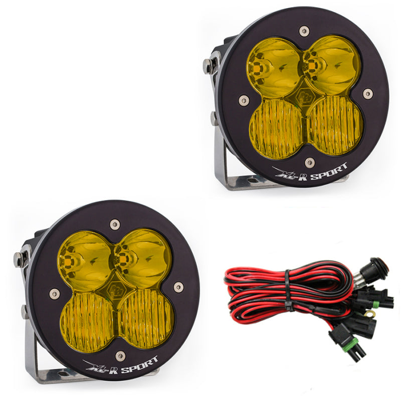 Baja Designs XL-R Sport amber driving lights pair with mounting brackets and wiring harness for offroad vehicles.
