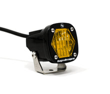 Load image into Gallery viewer, Baja Designs S1 Amber Wide Cornering LED light with mounting bracket for enhanced visibility and off-road performance.